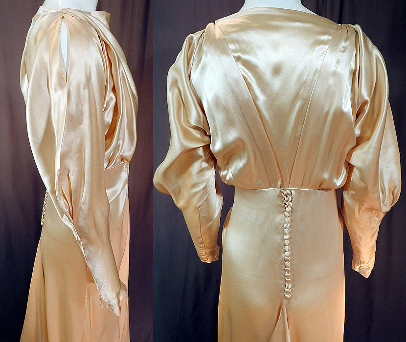 Vintage Cream Silk Charmeuse Cutout Sleeve Bias Cut Wedding Gown Train Dress
The dress measures 58 inches long in the front, 72 inches long in the back with train, a 36 inch bust, 24 inch waist and 42 inch hips. It is in good condition, with only some slight faint underarm discoloration. This is truly an amazing piece of wearable wedding bridal art!