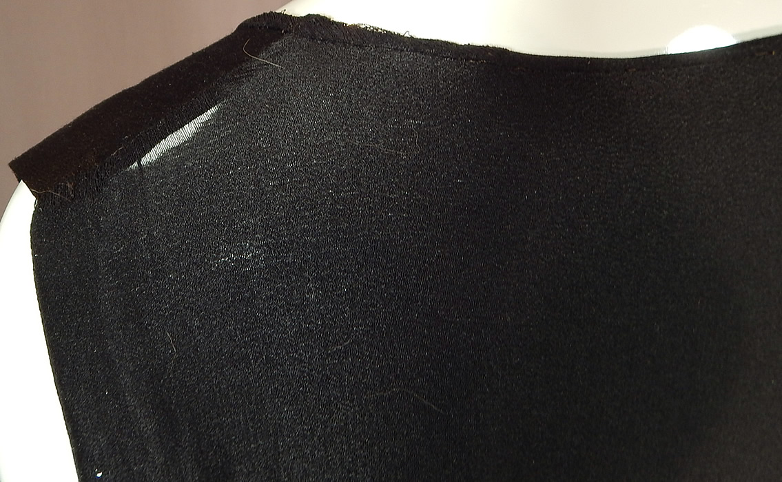 Vintage Black Silk Crepe de Chine Knotted Fringe Flapper Tabard Tunic Dress
The dress measures 39 inches long, with 8 inch long fringe, a 36 inch bust, 34 inch waist and 36 inch hips. It is in fair as-is condition, with a frayed split under one arm and back shoulder (see close-ups). 