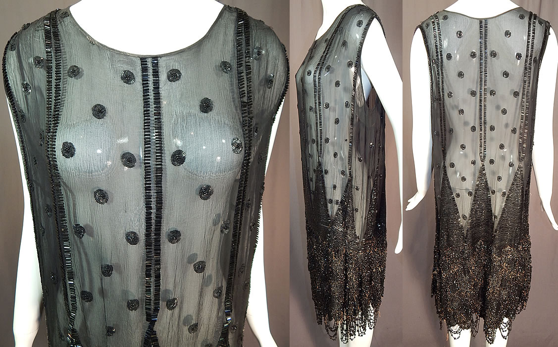 Vintage Art Deco Black Silk Sequin Polka Dot Jet Beaded Fringe Flapper Dress
This fabulous flapper dress has a loose fitting straight shift style, sleeveless, rounded scoop necklines and is sheer, unlined. The dress measures 40 inches long, with a 40 inch bust, 40 inch bust and 40 inch hips. It is in good as-is condition with some slight make-up discoloration along the neckline, faint small spots scattered on the mid section and has several loose missing beads on the bottom half skirt area. This is truly an exceptional piece of Art Deco wearable beaded textile art!