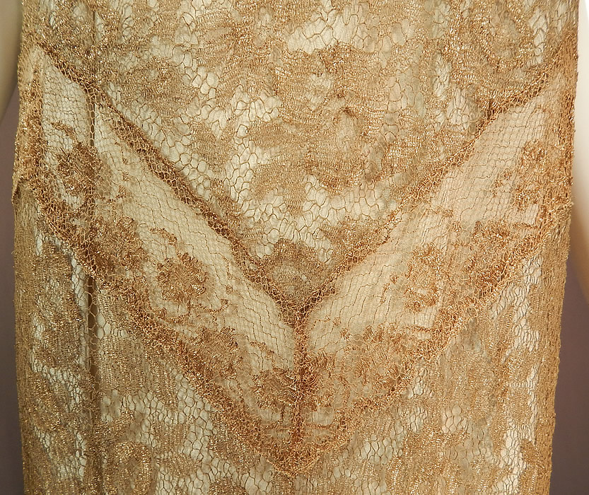 Vintage Gold Metallic Lam&eacute; Lame Lace Drop Waist Flapper Dress & Gray Silk Slip
This gorgeous gold dress is a long tea length, with a drop waist, gold lace insert coming to a V point at the waist and trimming the bottom skirt ruffle, sleeveless, with gold rope trim edging around the neckline, no side openings and is sheer, unlined. 