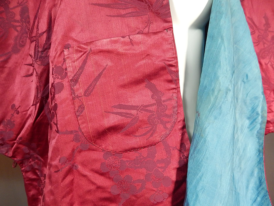 Antique Chinese Red Silk Damask Cherry Blossom Bamboo Brocade Magua Robe
This Manchu magua style riding jacket robe surcoat worn to protect ones clothing, is a short mid length, loose fitting, with side and back bottom slits for easy movement, a Mandarin collar, exaggerated long full wide sleeves, a hidden inside pocket, front side opening, with red silk loops, round carved brass button toggle closures and is fully lined in a blue silk.