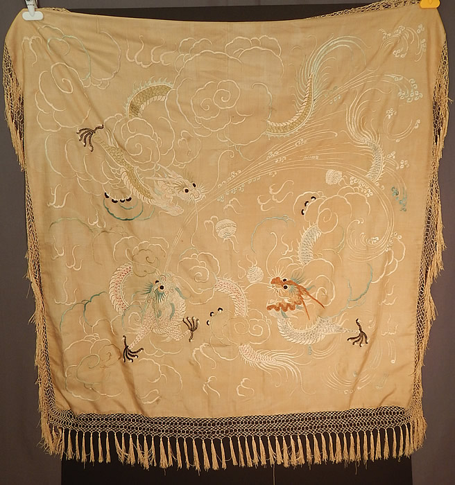 Antique Chinese Dragon Pongee Raw Silk Embroidery Fringe Shawl Tablecloth Tapestry
This antique Chinese dragon pongee raw silk embroidery fringe shawl tablecloth tapestry dates from the early 20th century during the Qing Dynasty. It is hand stitched, made of a soft thin woven unbleached raw silk pongee fabric, with muted silk raised padded satin stitch hand embroidery work with three dragons, clouds of smoke and pearls in the center.