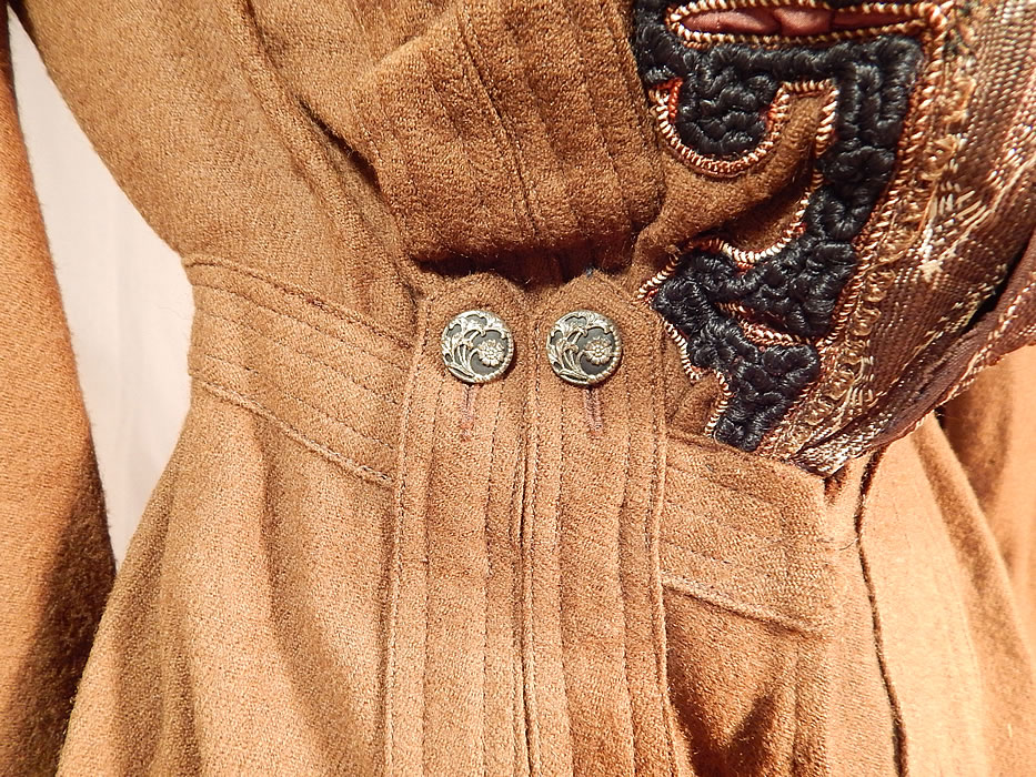 Victorian Brown Wool Soutache Button Trim Walking Suit Jacket Winter Coat
This wonderful winter walking suit coat jacket has a tailored, fitted long mid length, pouter pigeon style with stitched fabric appliqu&eacute; strip trim accents, decorative steel cut floral button trimmings on the back waist and front, gathered shoulders with long full sleeves, gauntlet cuffs, hook closures on the front and is lined in the top only with a brown polished cotton fabric inside.
