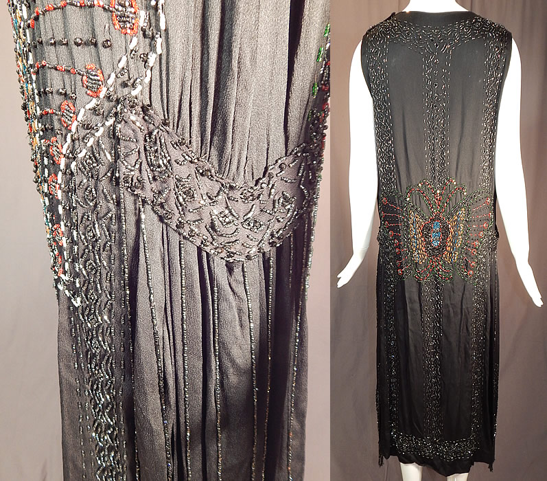 Vintage Art Deco Black Silk Colorful Beaded Butterfly Fringed Flapper Dress
This fabulous flapper dress has a loose fitting, drop waist, straight shift style, sleeveless, rounded scoop necklines, beaded fringe side strap draping skirt panels hanging down from the hips, shoulder snaps and is unlined. 