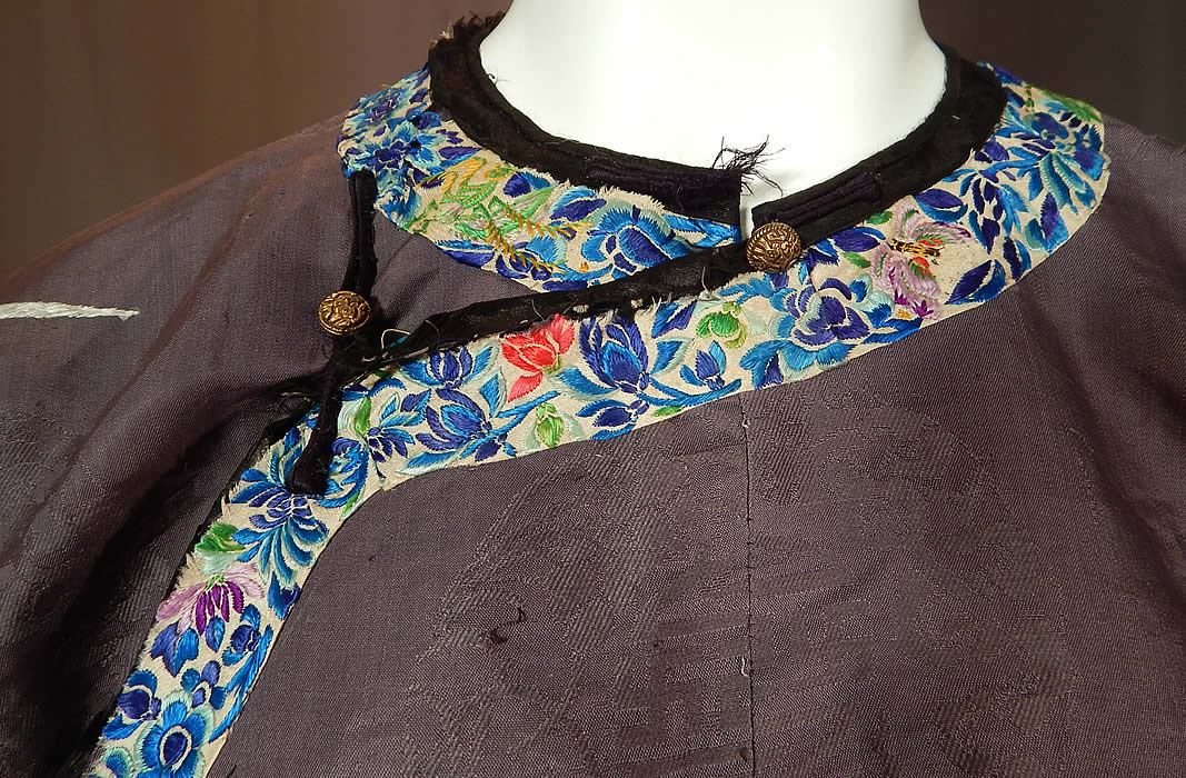 Antique Chinese Purple Silk Ji Brocade Embroidered Floral Cheongsam Qipao Robe
There is white silk colorful embroidered floral butterfly trim edging along the front side opening, collar and cuffs. This magnificent Manchu womens cheongsam qipao one piece dress style robe is a long floor length, with long full sleeves, a front side opening with round carved brass button, black silk loop toggle closures which some are missing, frayed or broken and is fully lined in a bright blue turquoise color silk lining inside. Manchu women wore a one-piece dress which were called "qipao" or "banner dress" and later became the traditional dress for Chinese women.