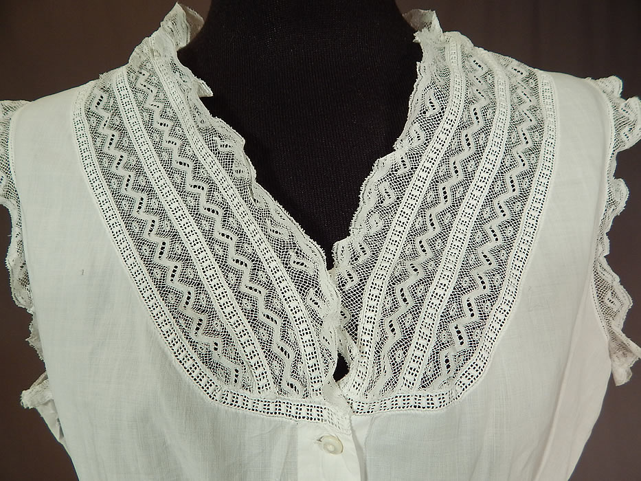 Victorian Lingerie White Cotton Batiste Lace Trim Camisole Corset Cover Top
There is a red monogrammed initial label sewn inside the bottom front opening. This lovely lacy lingerie camisole corset cover top undergarment has a form fitting style, sleeveless, with lace trim V neckline, peplum skirted waist and tiny mother of pearl button closures down the front. 