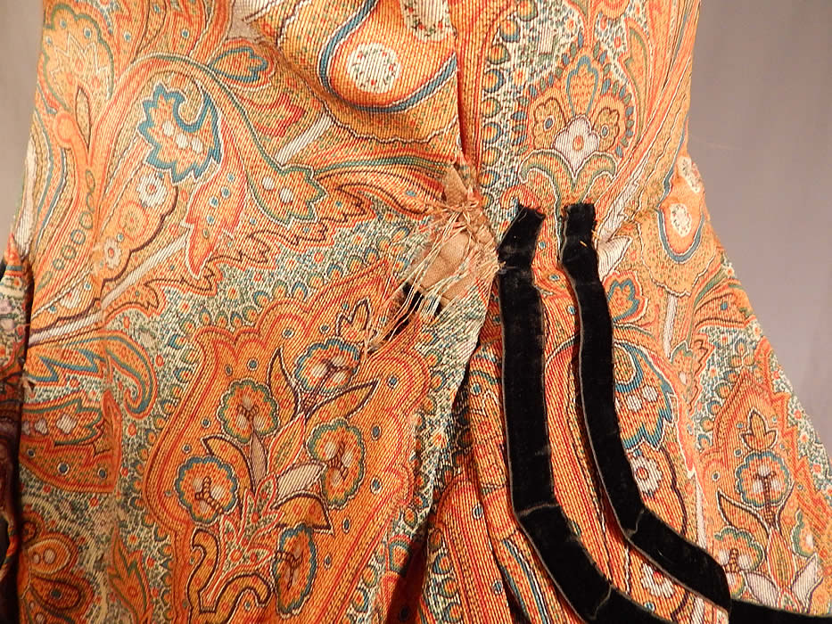 Victorian Civil War Era Paisley Wool Hoop Skirt Morning Wrapper Gown Dress
It is in fair as-is condition, missing the original buttons, has a small patched repair on the front top, some fraying around the neckline and several small frays in the fabric on the shoulder, back skirt, side pocket and underarm (see close-ups).
