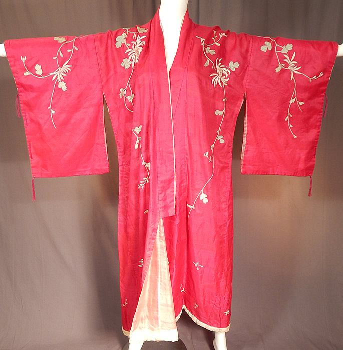 Vintage Japanese Fuchsia Pink Silk Chrysanthemum Embroidered Kimono Robe
This pretty pink Japanese kimono robe has an open front with a matching embroidered fabric belt with fringe trim ends for closure, a rolled padded cotton white silk covered hem, full kimono sleeves with woven knotted tassel fringe sides and is fully lined in a white fine tissue silk fabric inside. 