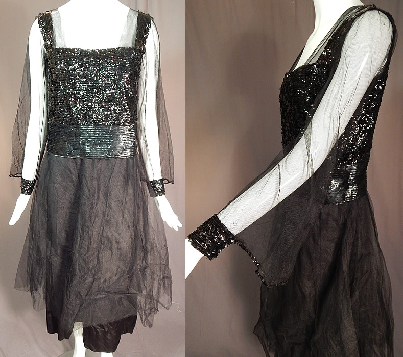 Vintage Art Deco Black Silk Tulle Net Sequin Beaded Evening Gown Flapper Dress
This vintage Art Deco black silk tulle net sequin beaded evening gown flapper dress dates from the 1920s. It is made of a black silk fabric underdress, with a sheer black tulle net overlay skirt, sleeves and black sequin beading covering the top. 
