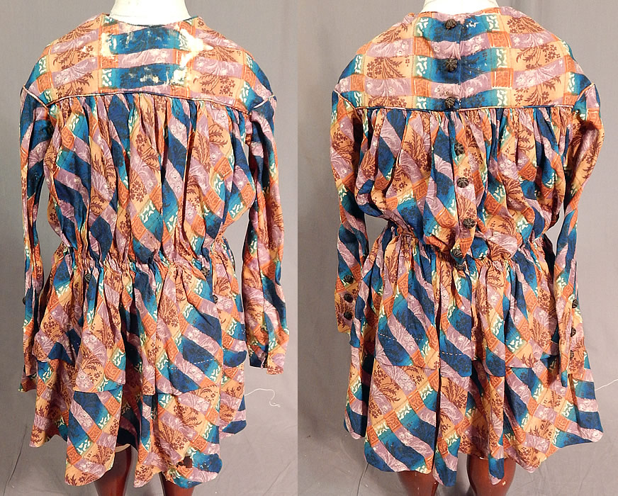 Victorian Civil War Era Childs Floral Patchwork Plaid Print Wool Button Back Dress
This antique Victorian Civil War era child's floral patchwork plaid print wool button back dress dates from the 1860s. It is hand stitched, made of a colorful indigo blue, mauve purple and brown floral leaf, plaid patchwork print fine wool fabric.
