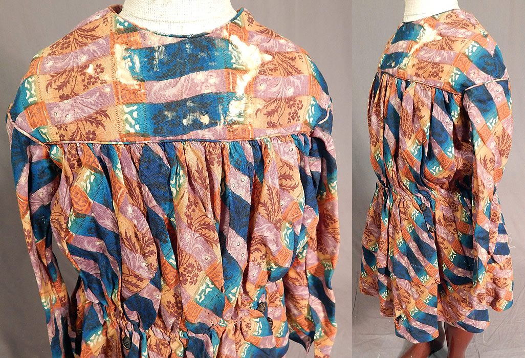 Victorian Civil War Era Childs Floral Patchwork Plaid Print Wool Button Back Dress
This charming child's dress could have been worn by either a boy or girl. It has a gathered waist, short full skirt with layered stitching, long sleeves, decorative black silk covered buttons down the back with hidden hook closures underneath and only the top yoke is lined. 