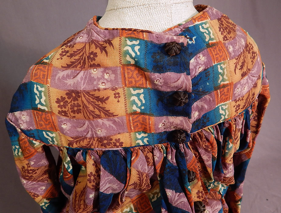 Victorian Civil War Era Childs Floral Patchwork Plaid Print Wool Button Back Dress
The dress measures 22 inches long, with a 26 inch chest, 20 inch waist, 13 inch long sleeve and 12 inch back. It is in fair as-is condition, with frayed holes on the front yoke which have been backed, patched, some staining on the inside and a frayed hole on the bottom front skirt (see close-ups). 