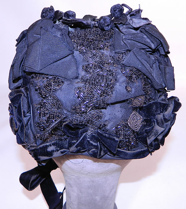 Victorian Black Silk Jet Beaded Trim Paris Label Mourning Bonnet Hat. There are black  silk velvet floral ball trim  and  black silk grosgrain ribbon bow trim on top. 