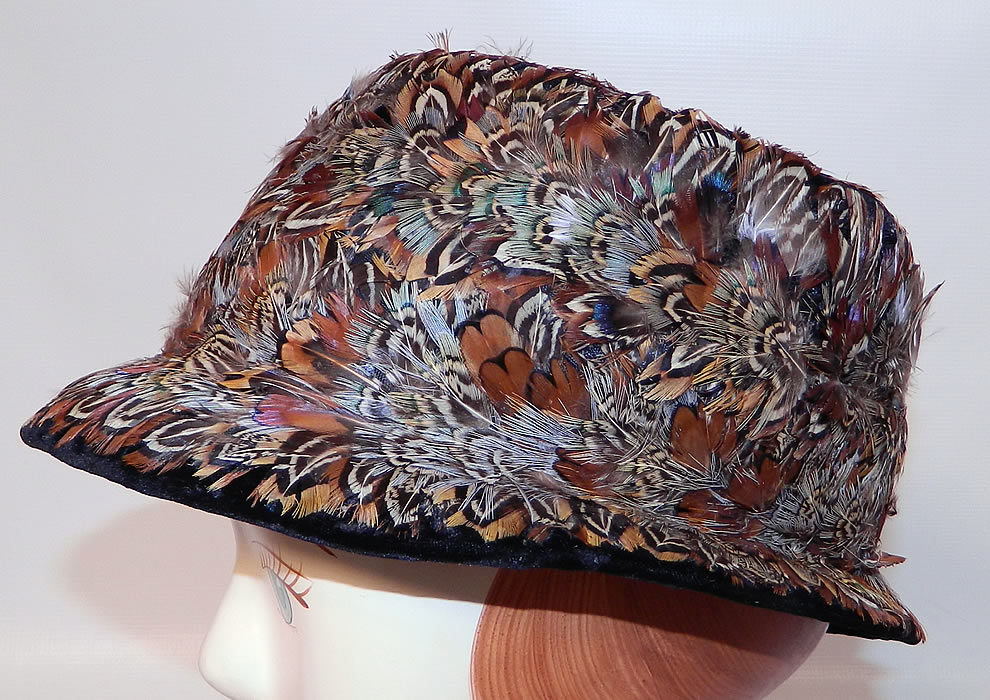 Vintage Womens Black Velvet Pheasant Feather Fedora Hat. It is made of a black velvet fabric base, covered with a variety of colorful pheasant bird feathers.