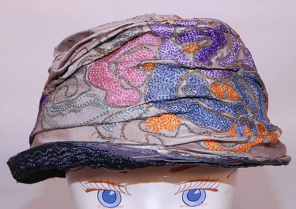 Vintage Art Deco Taupe Silk Colorful Crewel Chain Stitch Flapper Cloche Hat. The hat is made of brownish gray taupe color silk fabric, with gold metallic thread, multi-color crewel chain stitch embroidery work done in an Art Deco abstract floral design. 