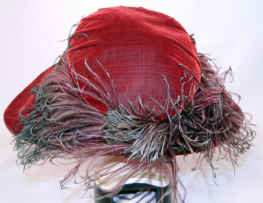 Vintage Fall Color Burgundy Red Velvet Feather Boa Trim Wide Brim Cloche Hat. This autumn fall color inspired hat has a very wide, uneven  asymmetrical oval shaped brim, which is wider along the sides and a muffin top crown. 