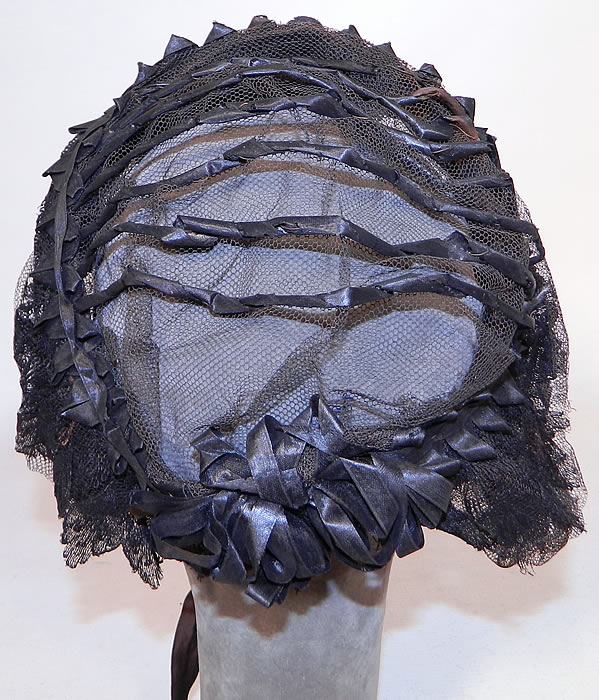 Victorian Civil War Era Black Net Ribbon Trim Mourning Bonnet Snood Headdress. This marvelous mourning bonnet snood style headdress has a sheer unlined crown, layered net front brim, ribbon trim back curtain and silk ribbon chin strap ties. 