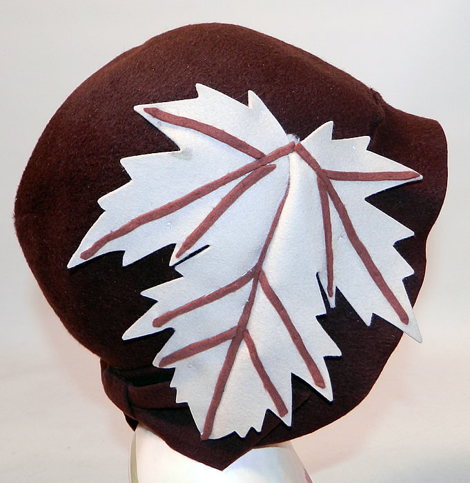 Vintage I Magnin & Co Brown Wool Felt Fall Maple Leaf Flapper Cloche Hat. The hat is made of brown wool felt fabric, with an off white cream color and brown wool felt applique maple leaf trim on the side. 