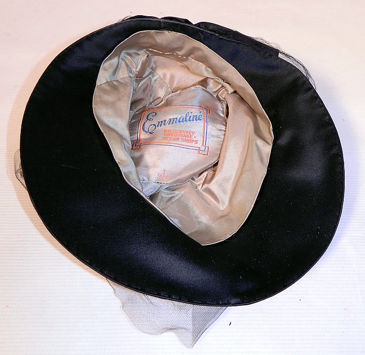 Vintage Emmaline Silver Lame Lam&eacute; Embroidered Sequin Trim Black Silk Wide Brim Cloche Hat. It is fully lined in silk, with a "Emmaline Exclusively Hand Made In Our Shops" label  inside.