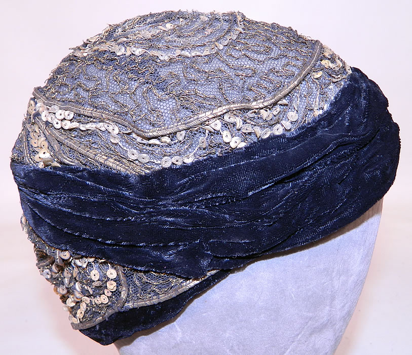 Vintage Art Deco Gold Lame Lam&eacute; Lace Net Sequin Black Velvet Flapper Cloche Hat. The hat is made of a sheer black net covered with gold metallic lam&eacute; trim embroidery stitching, sequins and black velvet fabric border edging along the bottom.