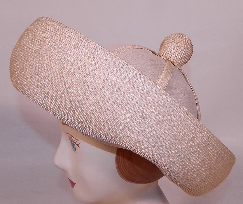 Vintage Oleg Cassini Woven Natural Straw Cream Silk Bumper Brim Hat. This vintage Oleg Cassini woven natural straw cream silk bumper brim hat dates from the 1960s.