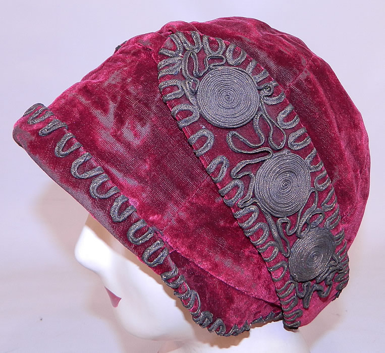 Vintage Art Deco Red Velvet Gold Lam&eacute; Soutache Trim Flapper Cloche Hat. The hat is made of a burgundy red color silk velvet fabric, with gold metallic lam&eacute; soutache embroidered trim edging on the brim and side flaps.