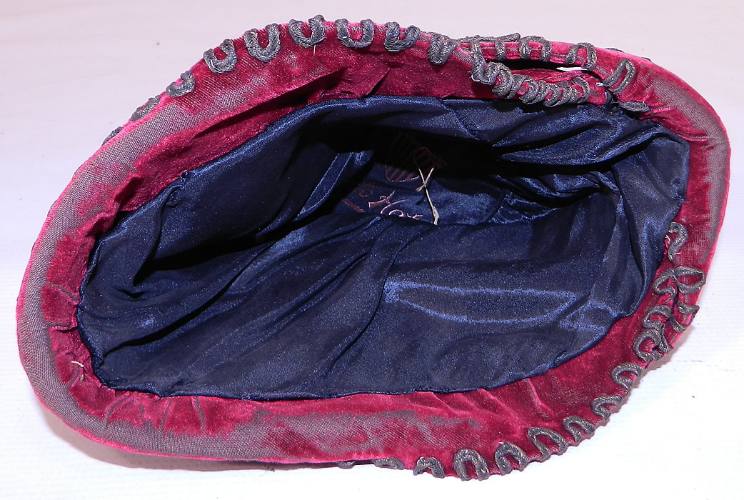 Vintage Art Deco Red Velvet Gold Lam&eacute; Soutache Trim Flapper Cloche Hat. It is in good condition, with some wear to the velvet nap in areas and around the front brim.