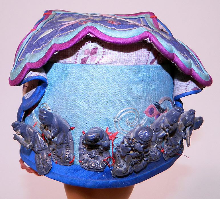 Antique Chinese Child Infant Silk Embroidered Silver Immortals Charm Wind Hat. 
This antique Chinese child infant silk embroidered silver immortals charm wind hat dates from the 1920s.