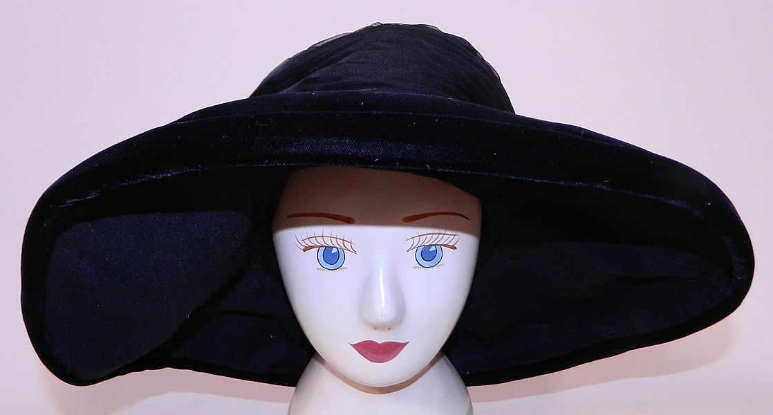 Vintage Joseph Magnin Black Pleated Ruched Silk Velvet Wide Brim Hat 
It is made of a black silk pleated ruched detailed crown, with a black velvet wide brim and black silk grosgrain ribbon hatband bow. 