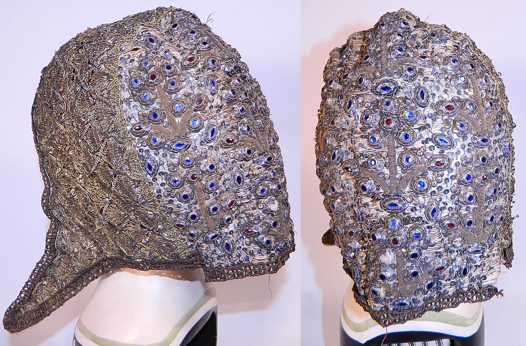 19th Century Antique Silver & Gold Bullion Jeweled German Folk Bonnet Cap
It is hand stitched, made of lace woven from thin strips of gold and a silk fabric back covered with silver thread, metal stump work, set with colored blue, red glass stones in a raised floral design and accented with silver metallic sequins. 