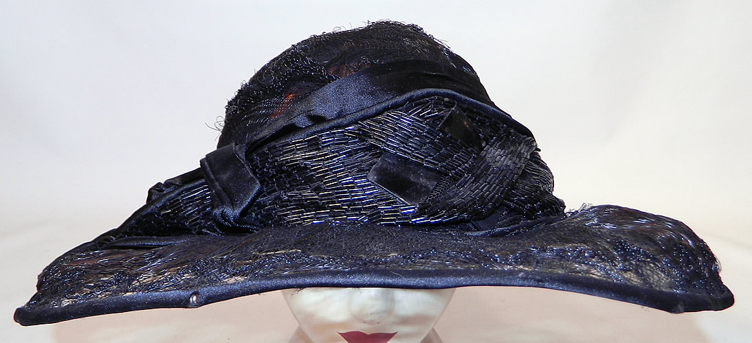 Vintage Burke Beaded Black Woven Horse Hair Straw Sheer Wide Brim Cloche Hat
The hat is made of a wire base, covered with a sheer woven black horse hair net straw and black silk trim edging. 