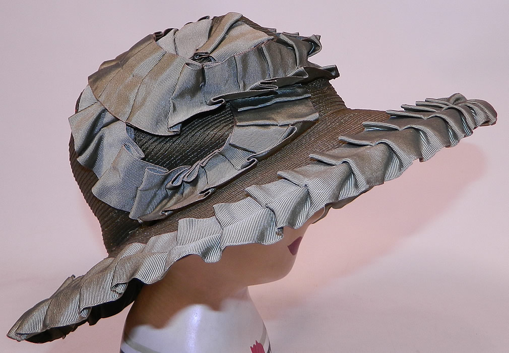 Vintage Sage Green Straw Silk Ribbon Ruffle Trim Wide Brim Cloche Hat
It is made of a sage green color woven straw, with matching silk grosgrain ribbon ruched ruffle trim edging. This fabulous flapper cloche style hat has a form fitting style with an uneven asymmetrical oval shape wide brim, which is wider along the sides and front.