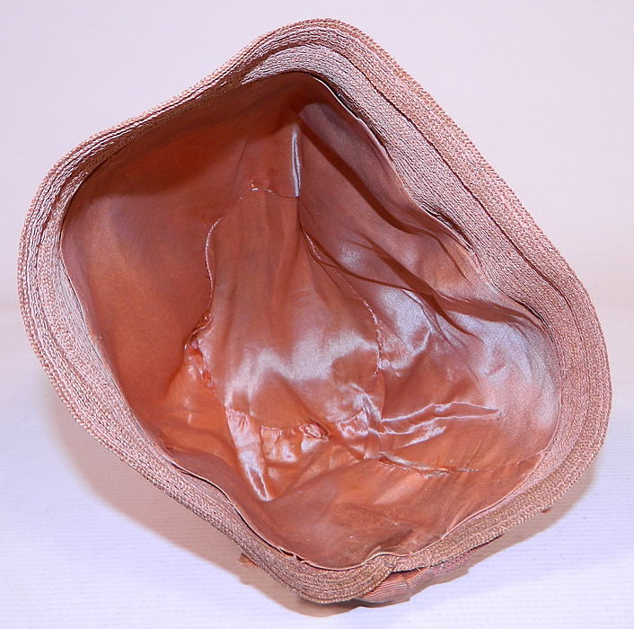 Vintage Art Deco Tango Pink Silk Ribbon & Woven Straw  Flapper Cloche Hat 
The hat measures 22 inches inside crown circumference. It is in good condition, with only some slight wear soiling dirty ribbon trim on the back. This is truly a wonderful piece of wearable Art Deco millinery art! 