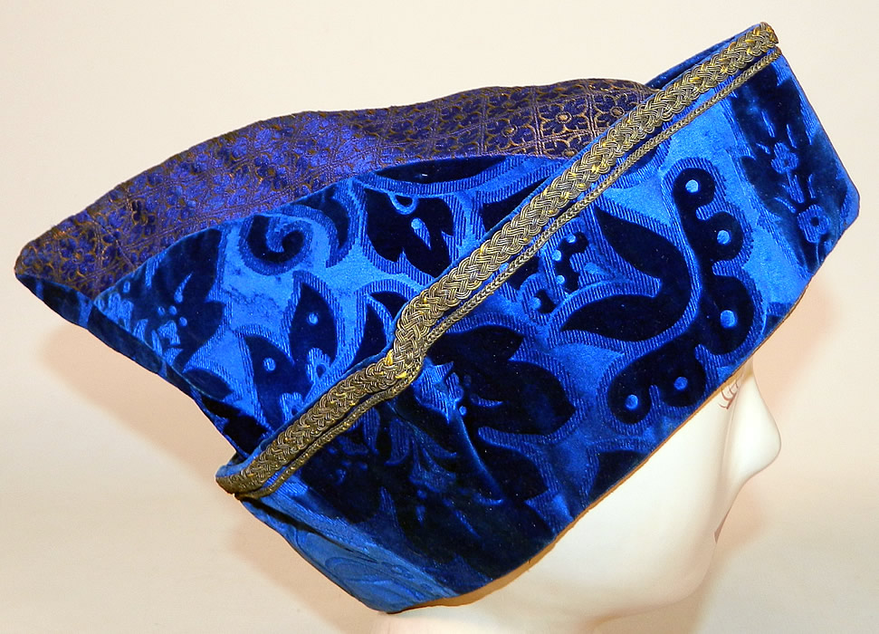 Vintage Hungary Regional Folk Costume Blue Burnout Voided Velvet Gold Trim Cap Archers Hat
It is made of a royal blue burnout voided velvet fabric with a floral leaf design, gold & blue silk fabric flower square print on top, gold bullion metal soutache embroidery and braided rope trim edging. 