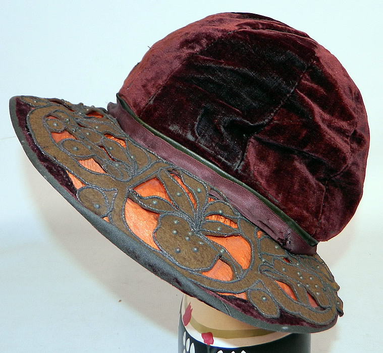 Vintage Burgundy Velvet Orange Silk Brown Cutwork Beaded Trim Wide Brim Cloche Hat
This vintage burgundy velvet orange silk brown cutwork beaded trim wide brim cloche hat dates from the 1920s.