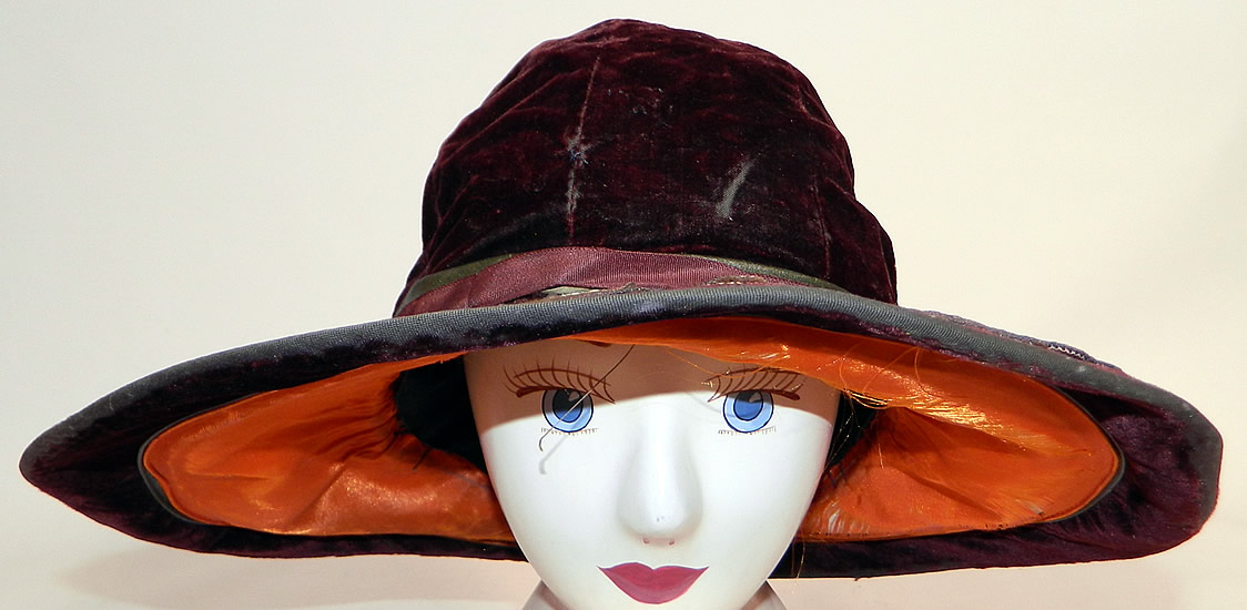 Vintage Burgundy Velvet Orange Silk Brown Cutwork Beaded Trim Wide Brim Cloche Hat
It is made of a dark red burgundy color fabric, with a orange silk lined brim covered with brown wool felt cut out fruit pears and apples trimmed with gold metallic soutache work and gold patina studded beading.