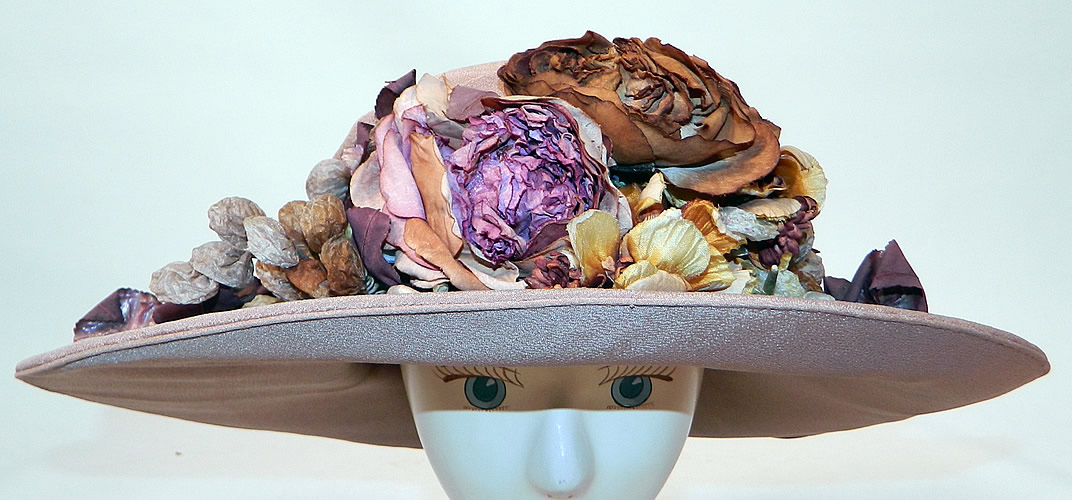 Edwardian Belle Epoque Taupe Silk Autumn Fall Floral Foliage Trim Wide Brim Hat
It is made of a grayish brown taupe color silk fabric, with colorful autumn fall foliage silk flowers and leaf trim on the front. 