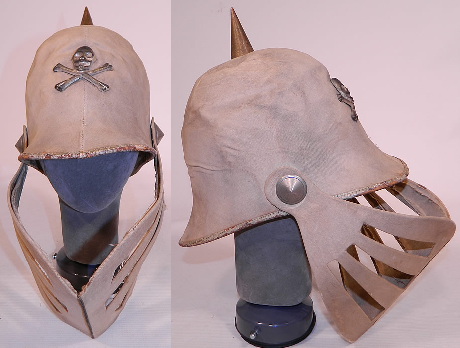 Vintage Odd Fellows Fraternal Skull Cross Bones Knights Louvered Visor Helmet Hat
This vintage antique Odd Fellows fraternal skull cross bones knights louvered visor helmet hat dates from 1900. It is made of an off white ecru cream color cotton canvas twill fabric covering a stiffened paper base, with a silver tone metal skull & crossbones insignia on the front and spike on top. 