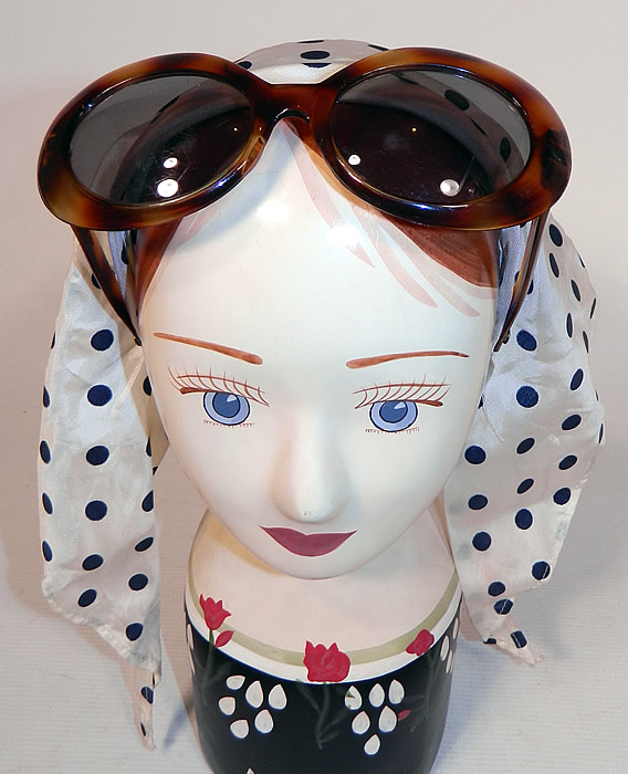 Vintage Audrey Hepburn Style Italian Polka Dot Headscarf Headband & Sunglasses
There is a headband with a white and blue polka dot silk headscrarf and sunglasses attached creating a one piece retro headpiece ensemble.