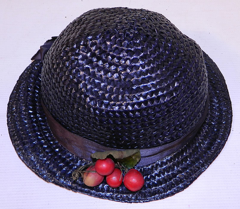 Vintage Navy Blue Woven Straw Red Cherry Silk Ribbon Bow Trim Childs Cloche Hat
The hat is made of a navy blue woven straw, with matching blue silk ribbon hat band bow and red cherry trim. 