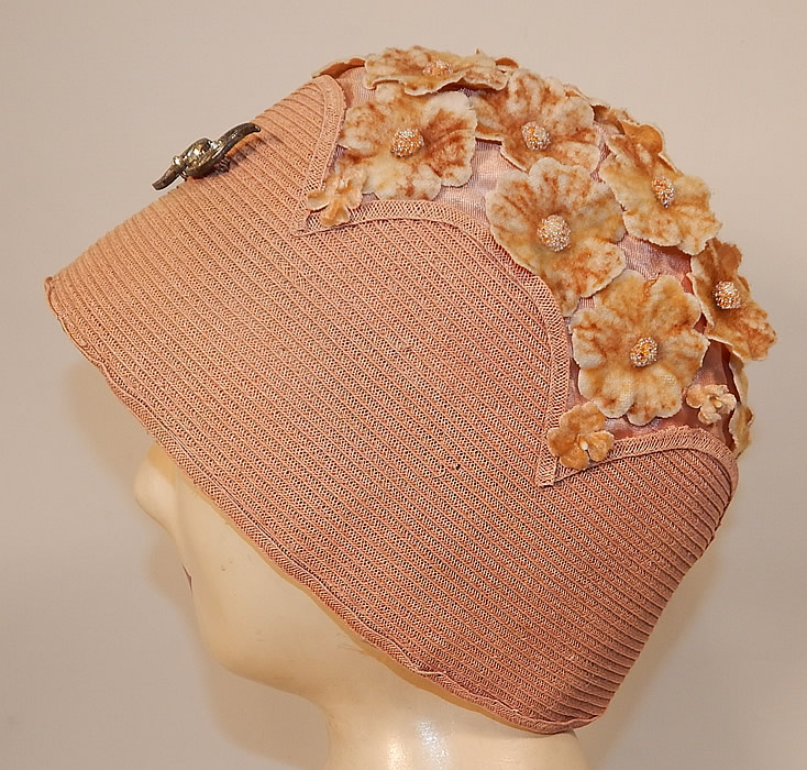 Vintage Peachy Pink Woven Straw Velvet Flower Applique Flapper Cloche Hat
It is made of a pastel peachy pink color woven straw fabric with scalloped edging and a matching color silk fabric lining on the top with tiny velvet flower appliques covering it.