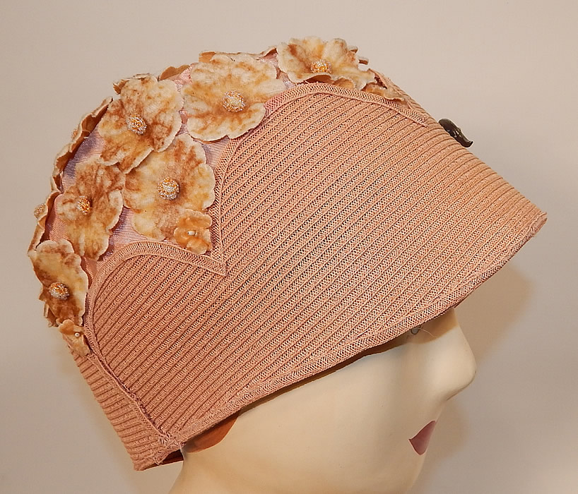 Vintage Peachy Pink Woven Straw Velvet Flower Applique Flapper Cloche Hat
This pretty pastel summer cloche hat has a form fitting style, with a silver metal rhinestone brooch pinned on the front for decoration and is unlined. 