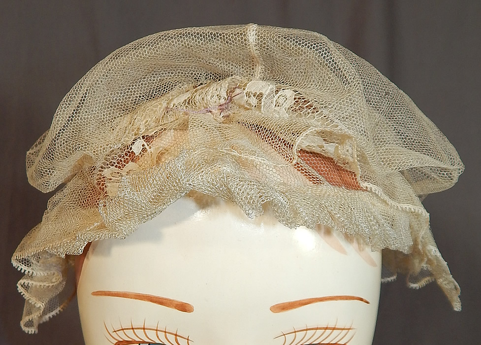 Victorian Civil War Era Antique Cream Net Lace Bed Cap Morning Bonnet Hat
It is made of a sheer fine off white cream color tulle net fabric, with Chantilly lace ruffle trim wired edging encircling the head. 