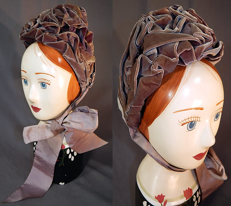 Victorian Purple Lavender Silk Velvet Ruched Gathered Small Half Bonnet Hat
This antique Victorian era purple lavender silk velvet ruched gathered small half bonnet hat dates from the 1880s. It is made of a grayish purple lavender color silk velvet fabric with ruched gathering.