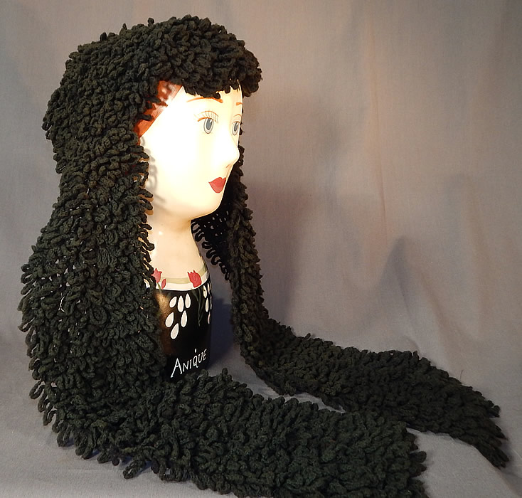 Victorian Black Boucle Looped Wool Hand Knit Winter Bonnet Lappet Scarf
This unique women's winter bonnet hood headdress would have been worn for travel in a sled or carriage and has a head scarf style with long lappet end ties, a triangle shape top covering the head and is unlined. 