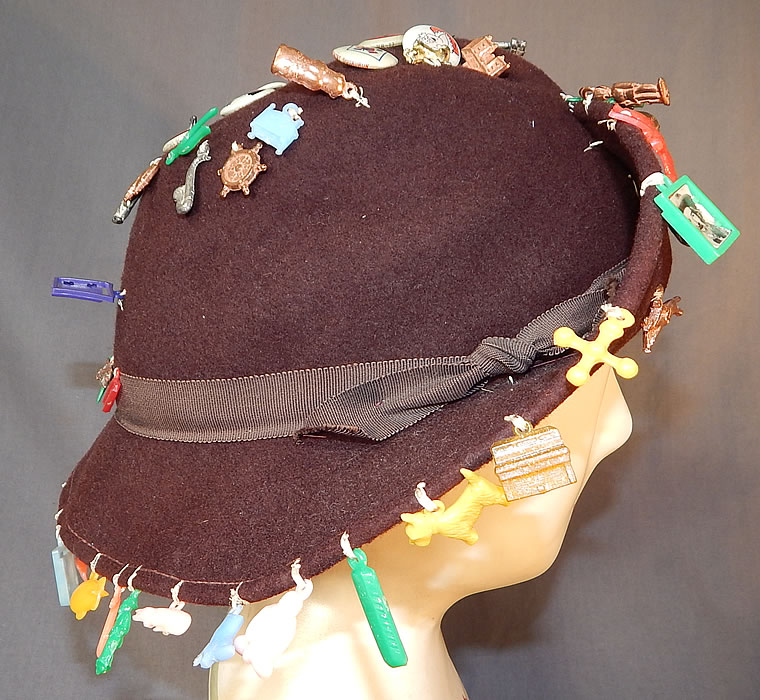 Vintage Cracker Jack Prize Toy Charms Pep Pins Roy Rogers Jane Russell Hat
It is made of a brown wool felt fabric, with colorful plastic and metal children's charms sewn onto it. 
