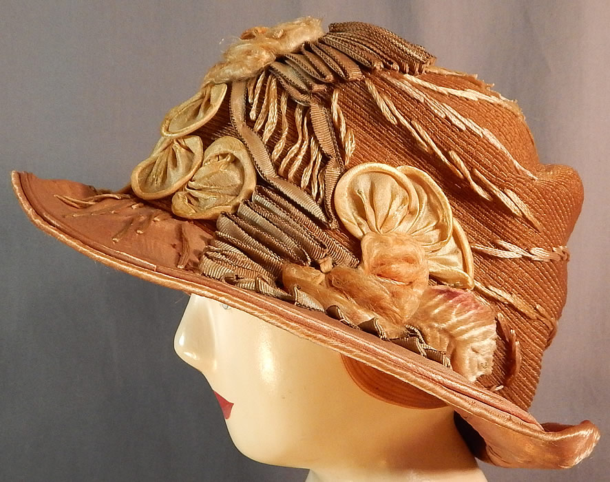 Vintage M. Lurie & Co Harvest Gold Woven Silk Ribbon Rosette Wide Brim Cloche Hat
The hat is made of a harvest gold color silk brim fabric, woven horse hair straw and ombre color silk ribbon work embroidered trim, velvet leaf, silk rosette flower trim on the crown. 