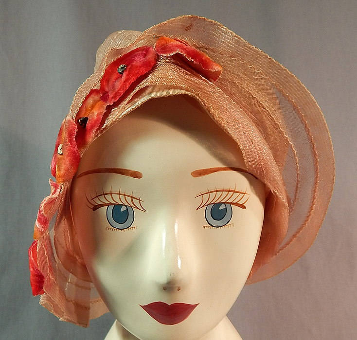 Vintage Art Deco Woven Pink Pastel Red Velvet Flower Flapper Cloche Hat
The hat is made of a sheer woven pale pink pastel horse hair net straw, with reddish orange ombre velvet flower applique trim on one side. 