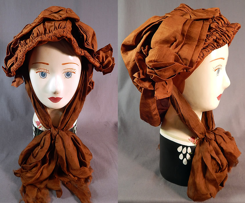 Edwardian Pleated Brown Silk Horseless Carriage Motoring Bonnet Cap Womens Hat
This antique Edwardian era pleated brown silk horseless carriage motoring bonnet cap womens hat dates from 1910. It is made of a brown silk fabric with a wired frame front brim covered with pleated ruched gathering and a hair snood style back to protect and cover the hair.