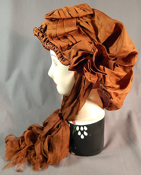 Edwardian Pleated Brown Silk Horseless Carriage Motoring Bonnet Cap Womens Hat
This womens traveling bonnet hood would have been worn for travel in a horseless carriage motor car and has brown sheer silk chiffon scarf ties for securing under the chin. 